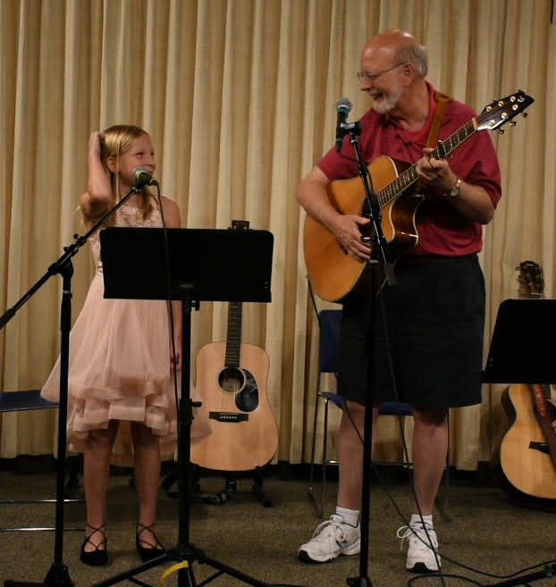 Tom Atkinson performs with his granddaughter Dakota at a Coffee House, about 2012.