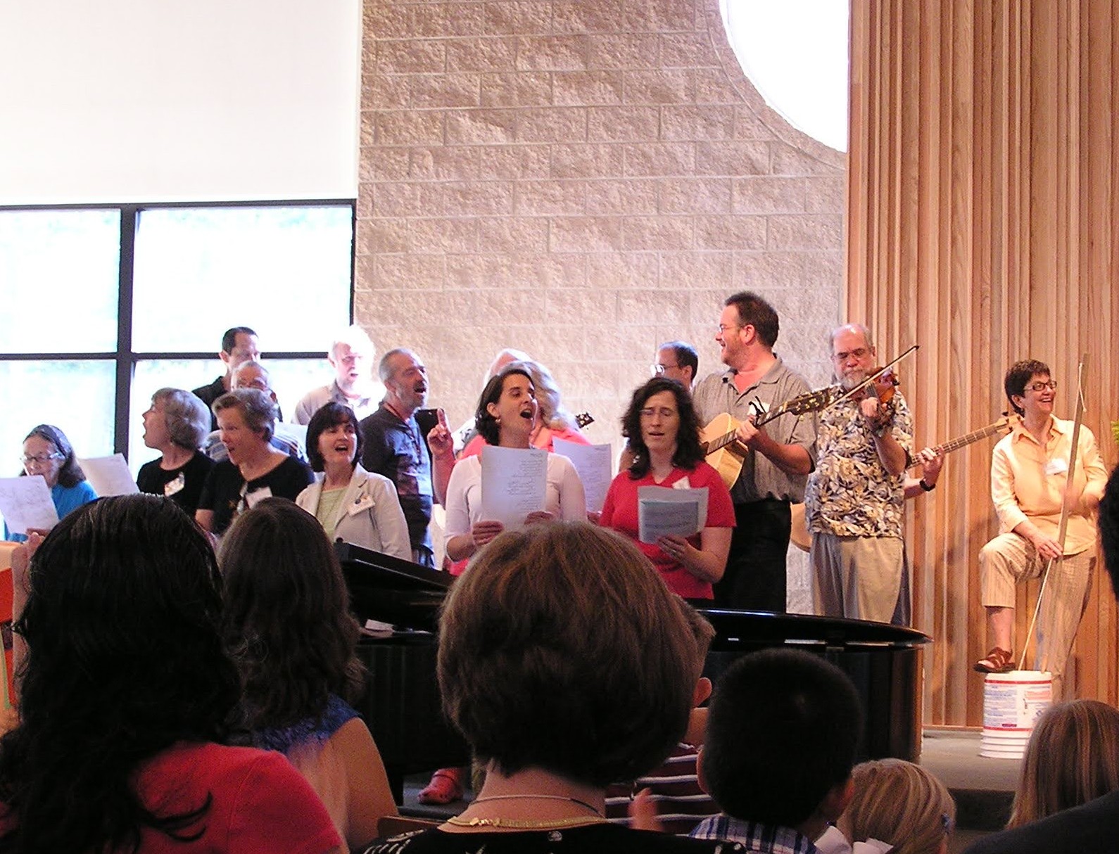 Folky Friday group performs at a UUFR service, 2006. Choir director Dan Smith plays guitar